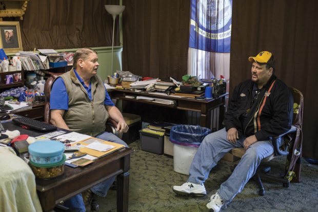 Mark Perkins, left, and Scott Pearce talk about recent layoffs from the nearby Black Thunder Coal Mine at Perkins' electrical shop in Wright, Wyo., on April 5, 2016. Perkins is closing his business after the mine laid off hundreds of workers, including Pearce, due to a dramatic decline in demand for coal. The town, with a population of less than 2,000, relies heavily on the energy industry to sustain itself. As energy prices and demand for coal decline the state is struggling to support it's ailing, energy-dependent economy.