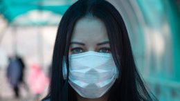 Girl in a medical mask on the street during the coronavirus epidemic in Russia. Photo credit: vperemen.com